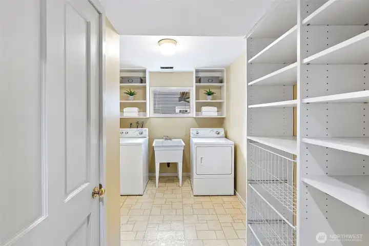 Utility room with additional storage and utility sink.