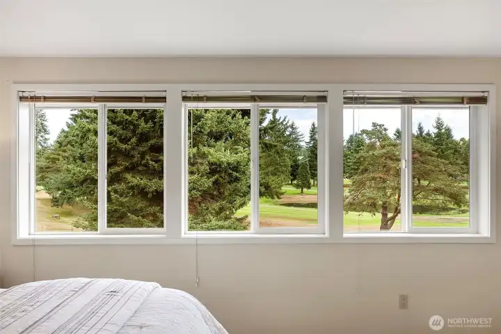 Primary bedroom with views of the golf course.
