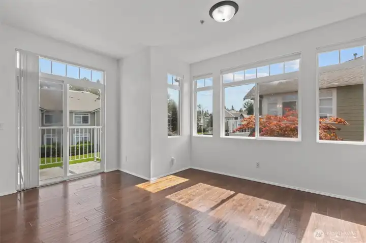 Bright open living room with vaulted ceilings, skylights, and cozy gas fireplace