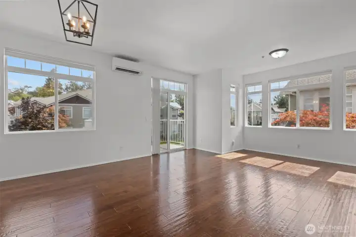 Bright open living room with vaulted ceilings, skylights, and cozy gas fireplace