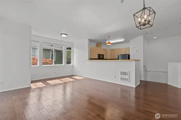 Bright open living room with vaulted ceilings, skylights, and cozy gas fireplace