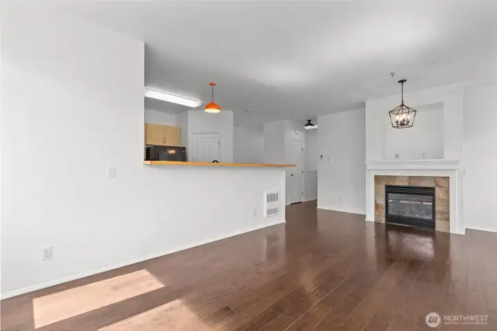 Bright open living room with vaulted ceilings, skylights, and cozy gas fireplace