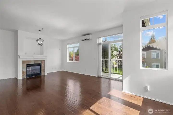 Bright open living room with vaulted ceilings, skylights, and cozy gas fireplace