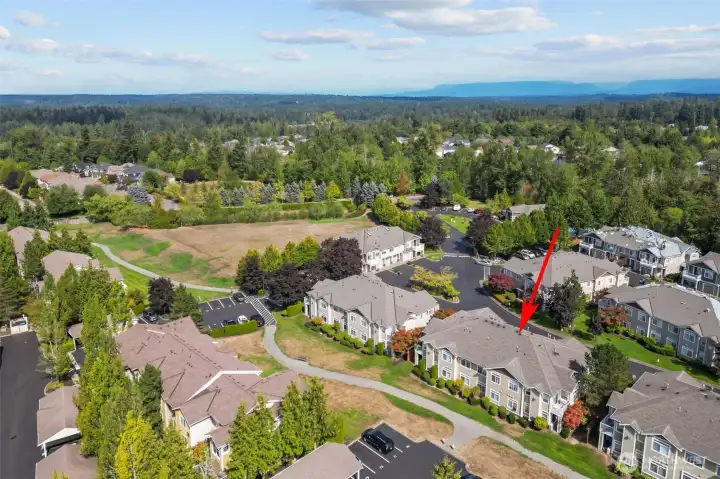 Resort-style amenities including outdoor pool, clubhouse, gym, and walking trails