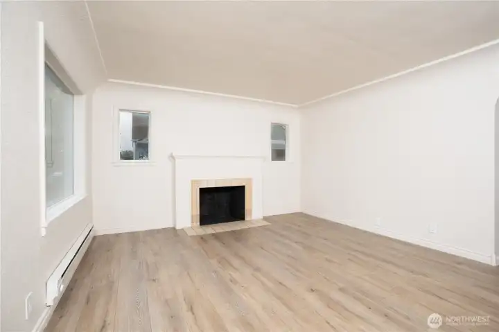 The spacious living room features a charming fireplace and excellent natural light. With fresh paint and new trim and flooring, this home makes an excellent starter!