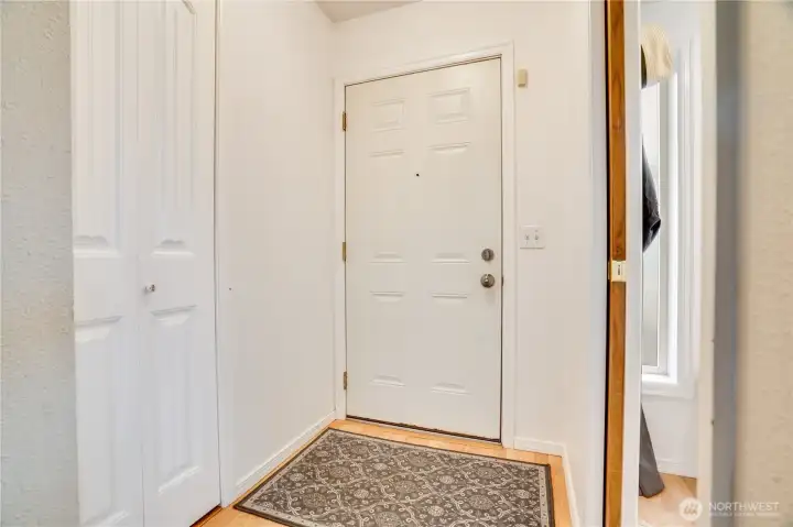 Now that we've given a short preview, let's start at the very beginning. Come in through the front door to this entry with a coat closet on one side, and a pocket door leading to a small front room on the other.