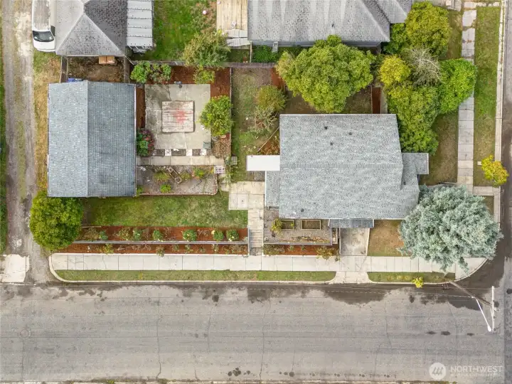 The 6,240 square foot lot includes a 2-car detached garage. Notice the terraced rose garden bordering D Street and the raised beds beside the kitchen for growing veggies, flowers, and herbs.
