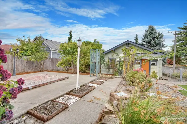 It's clear how much love and thought went into designing and planting this garden. From here you can see the large patio, ornamental grasses, climbing roses, lilacs, hydrangea, and rhododendron.