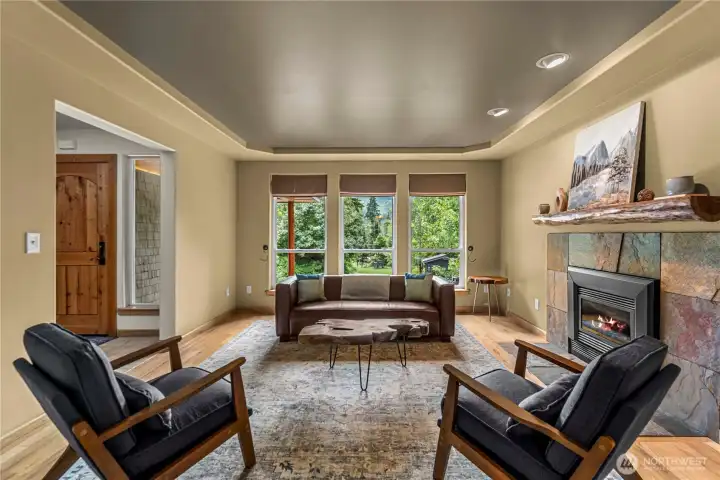 A wall of windows frames mountain views while the gas fireplace sets the mood - invites slow mornings, relaxed evenings, and quiet moments surrounded by handcrafted charm.