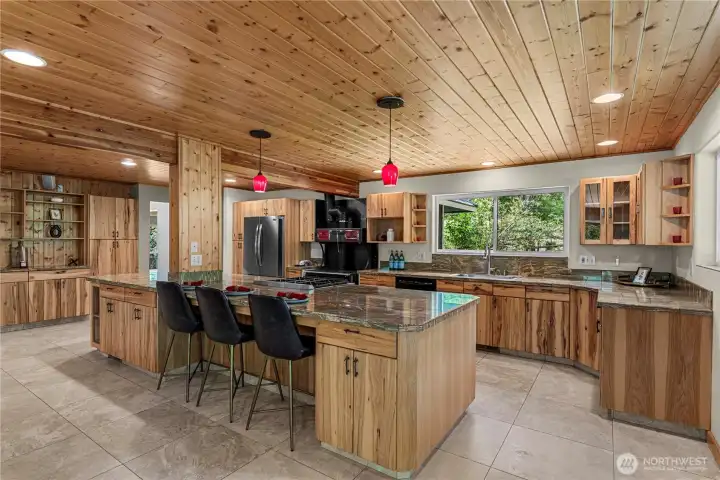 With rich wood cabinetry, expansive granite counters, and a generous island for gathering, this kitchen is a host’s dream - ready for everything from holiday feasts to impromptu nights with friends.