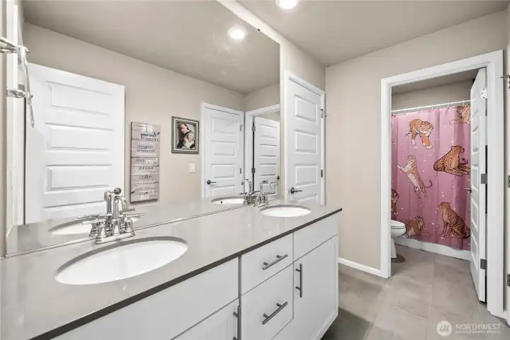 Jack and Jill bathroom with double sinks and separation between the bathtub for multiple people using it at once!