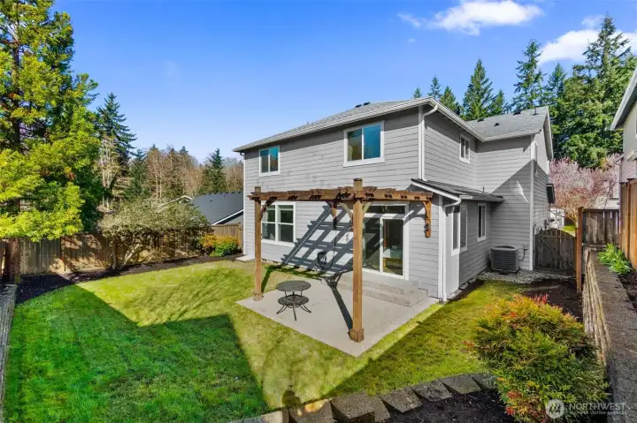 Inviting back yard with pergla covered patio.
