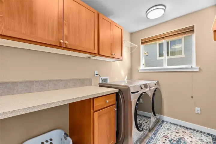 The laundry room with cabinets and counterspace is upstairs.