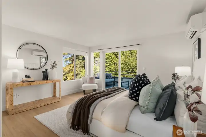 Primary suite with bright sunshine and new luxury plank flooring.  Views, private deck, walk in closet, AND air conditioning? Yes please.