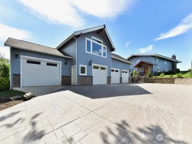 Stamped concrete driveway and 4 car garage.  DADU located above garage.