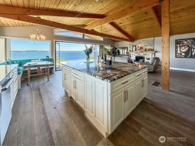 Great room concept opens the kitchen, living and dining rooms to the water views.