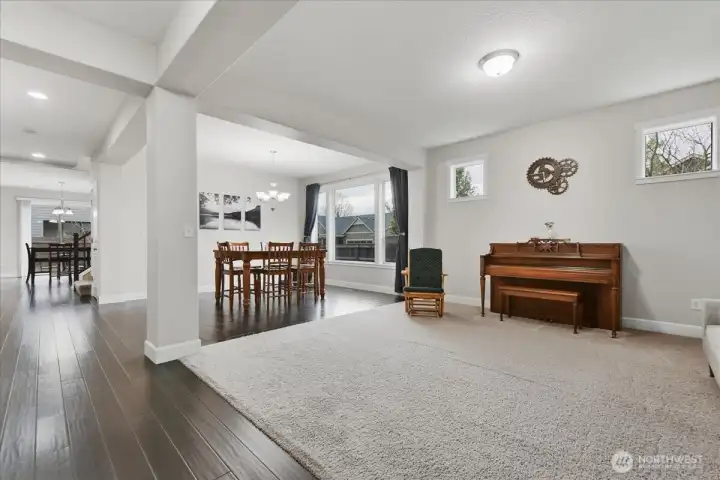 Living room, carpet, foyer w/ engineered hardwood
