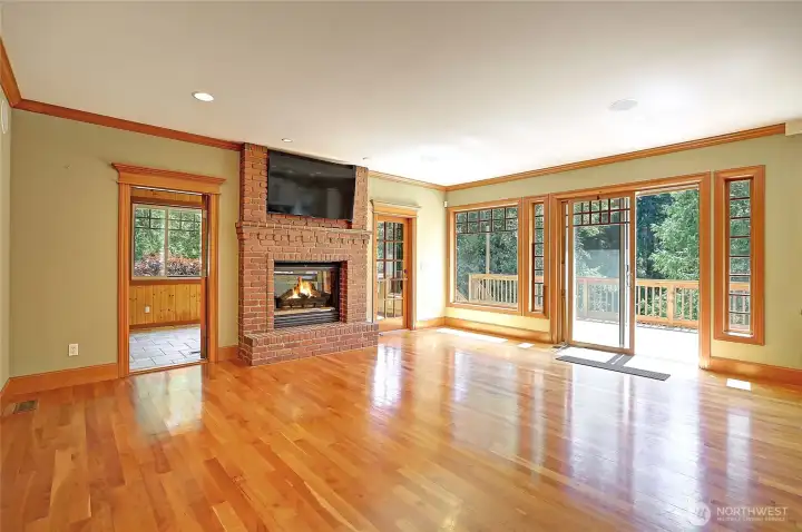Living room w/ gas fire place, access to huge entertainment deck & sun room.