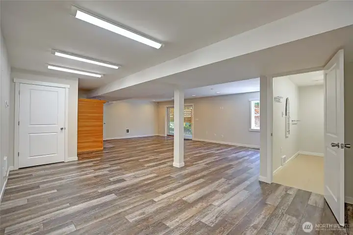 Living room/rec area on lower level w/ sauna & laundry room to the right.