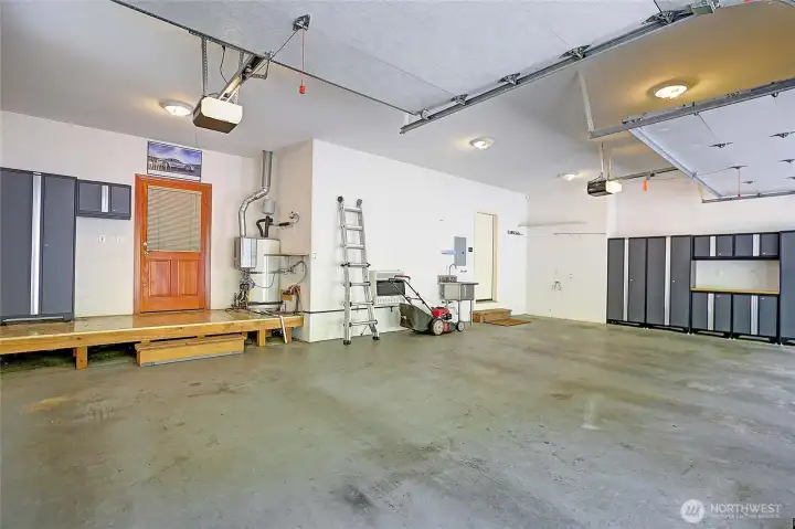 Main home's 3 car garage with tons of storage/cabinets.