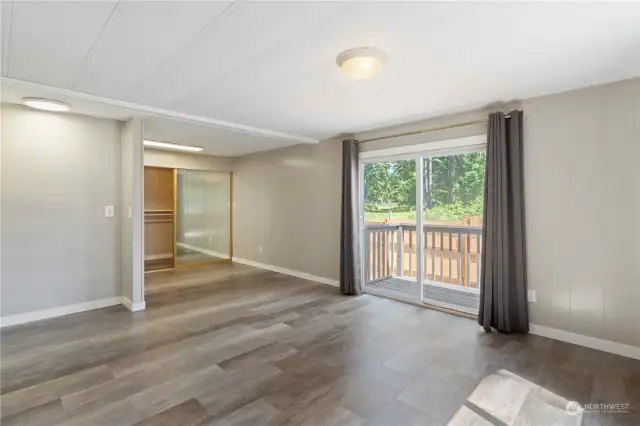 Another view of the primary bedroom with slider to a private side deck.