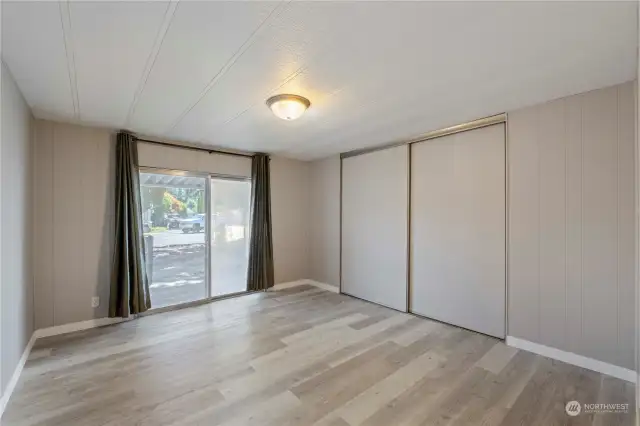 Guest bedroom with slider to front porch.