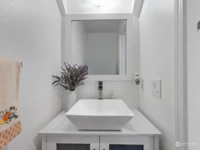 Main/lower level powder room with updated vanity.