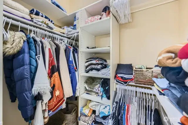 Primary walk-in closet with organizers.