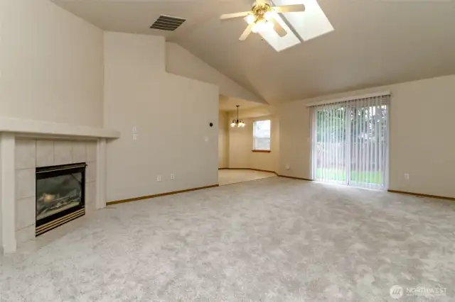 Light filled family room with soaring ceiling and skylights.