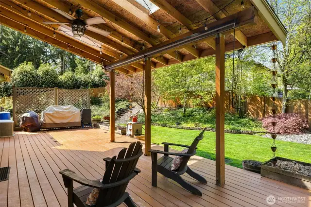Covered Timbertech deck goes out to beautiful yard.