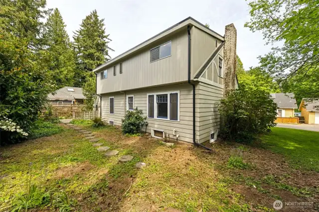 Back view of the two story home, with a cute little partially fenced back yard.
