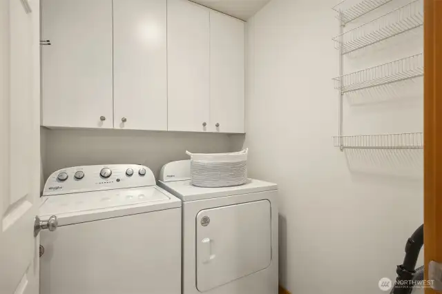 The laundry room on the main floor features plenty of storage.