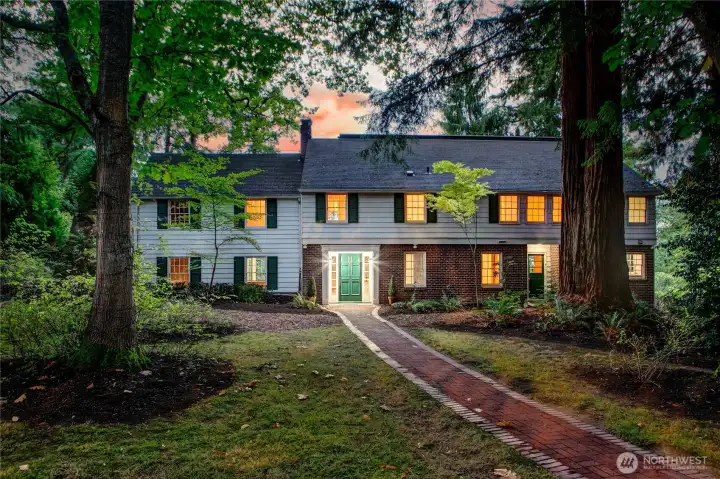 Anchored at the heart of Evergreen Lakeshore Preserve, this stately colonial home radiates timeless charm and quiet grandeur. Framed by towering evergreens and a gently winding brick path, it welcomes you with a sense of permanence and grace. The warm glow from its windows speaks to generations of gatherings, laughter, and life lived close to nature. Though modestly elegant, the home carries with it the legacy of stewardship and the invitation to continue a story that began nearly a century ago.
