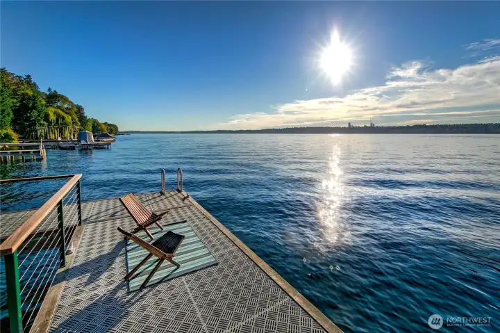 Stretching out into the glistening expanse of Lake Washington, the dock at Evergreen Lakeshore Preserve invites you to pause, breathe, and take in the vast horizon. With sunlight dancing on the water and the Seattle skyline in the distance, this is a front-row seat to nature’s grandeur and the rhythm of lake life. Whether for morning reflections, casting a line, or launching an afternoon paddle, this is where serenity meets possibility—where the shoreline becomes a sanctuary.