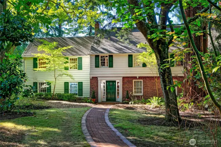 Set beneath a leafy canopy at the heart of the estate, this classic Colonial residence exudes timeless charm. A brick path winds through filtered sunlight toward a home rich with character and presence—perfectly situated to honor its historic roots while offering a launching point for future generations. Whether preserved, reimagined, or replaced, the home stands as a testament to the site’s rare blend of legacy, privacy, and possibility.
