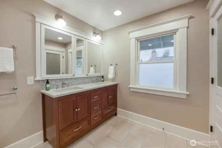 Primary bath upstairs with double vanity and heated flooring.