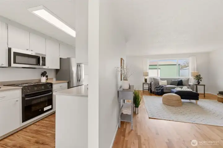 This view shows the kitchen and living room from the entry.