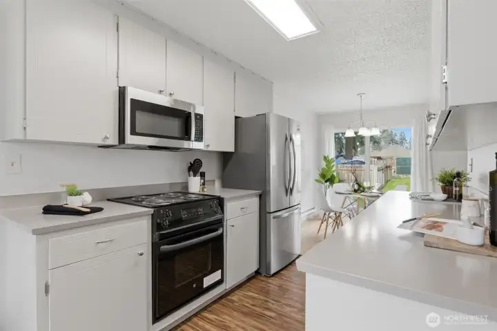 The well- equipped kitchen opens onto the dining room.