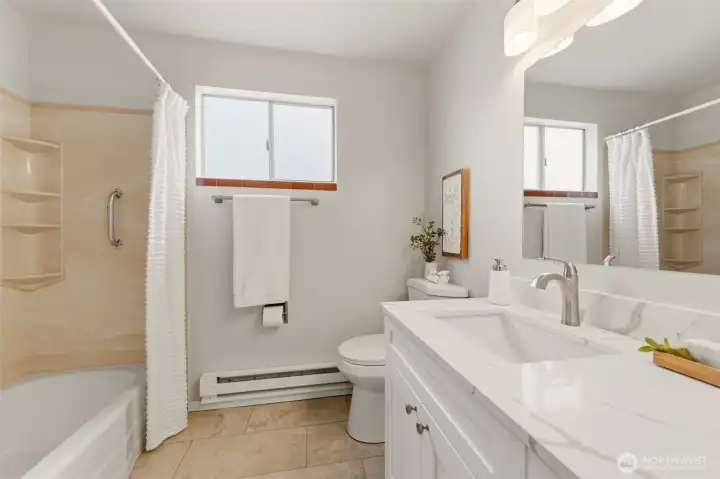At the end of the hallway is this delightfully updated full bathroom.