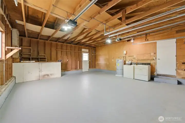 The home has an oversized two-car garage where the washer/dryer and a workbench is located.