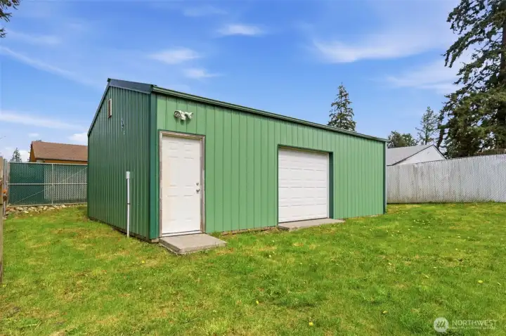 The shop has a man door and a full sized door that face the home and a double door out to the alley access.