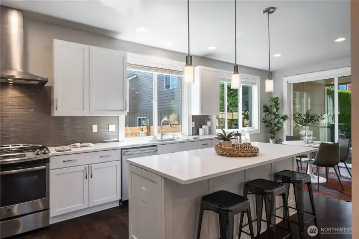 Beautiful quartz countertops with bar top seating.