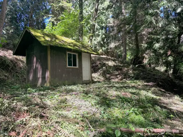 A small shed sits quietly on the SW corner. Lockbox attached to shed for viewing.