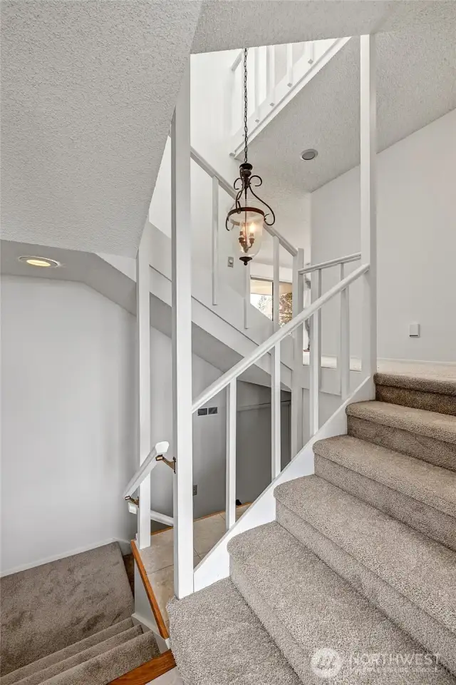 Entry landing at the front door, and the stairs down lead to the 2 car garage. New carpet throughout that was installed just before listing day
