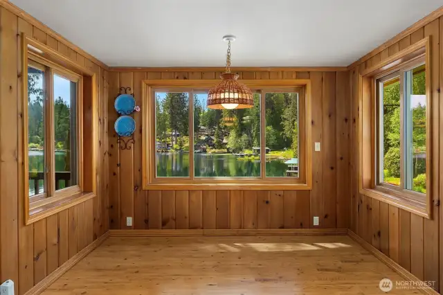 Dining room framed by windows creating abundant natural light and views.