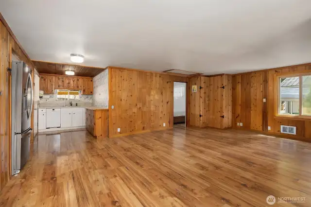 Open flow of living area featuring corner storage closet.