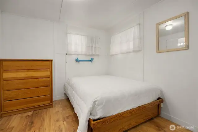Spacious bedroom with windows for natural light.