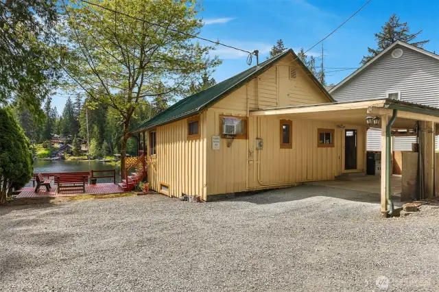 Back of home with covered parking area.