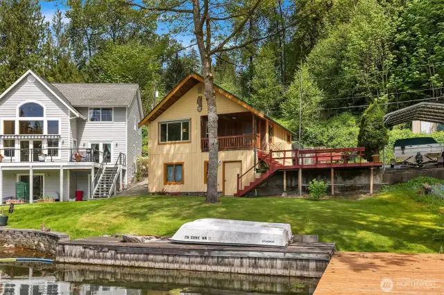 Lucious greenery surrounding home, with close proximity to lake and dock.
