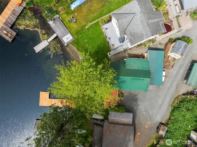 Aerial view of home featuring covered parking area and additional living space.